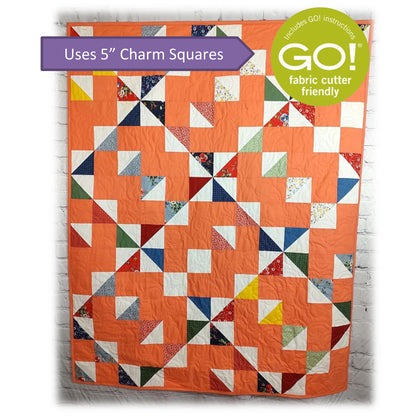 Charming quilt in peach with diamonds and squares design with note about this pattern being Accuquilt GO! fabric cutter friendly and that it uses 5-inch charm squares.