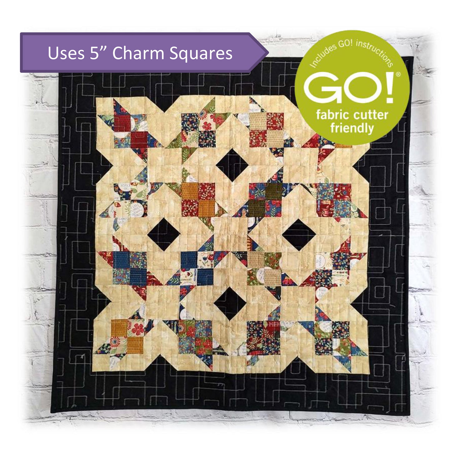 Charming quilt showcases a beautiful patchwork design with note about this pattern being Accuquilt GO! fabric cutter friendly and that it uses 5-inch charm squares.