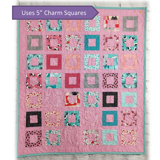 Colorful quilt in pink with rows and columns of frames in different colors.