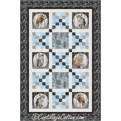 Stunning blue and brown quilt showcasing blocks of owls interchanged with blocks in a X design making it look like diamonds of color between blocks of owls and inside blocks of trees.