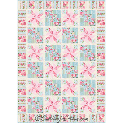 Colorful quilt with pink and blue flowers fabric with some squares filled with pinwheels.