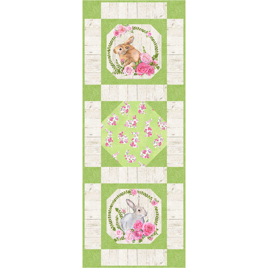 Green and white quilted table runner with bunny and flowers design.