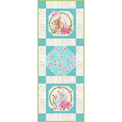 Turquoise and white quilted table runner with bunny and flowers design.
