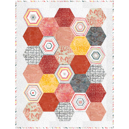 Quilt with orange, yellow, and gray hexagon design.