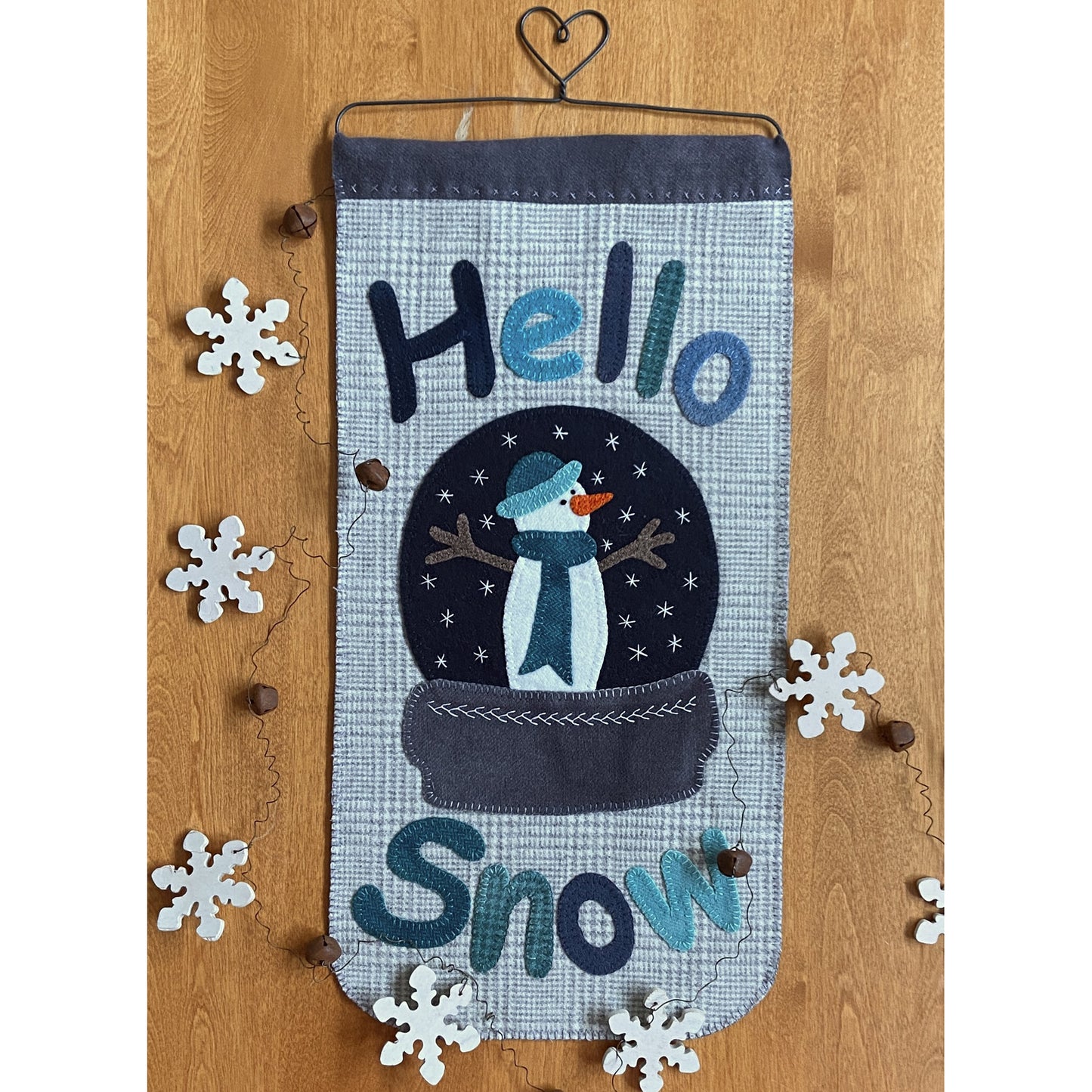 Festive snowman in a snow globe banner includes "Hello Snow" message.