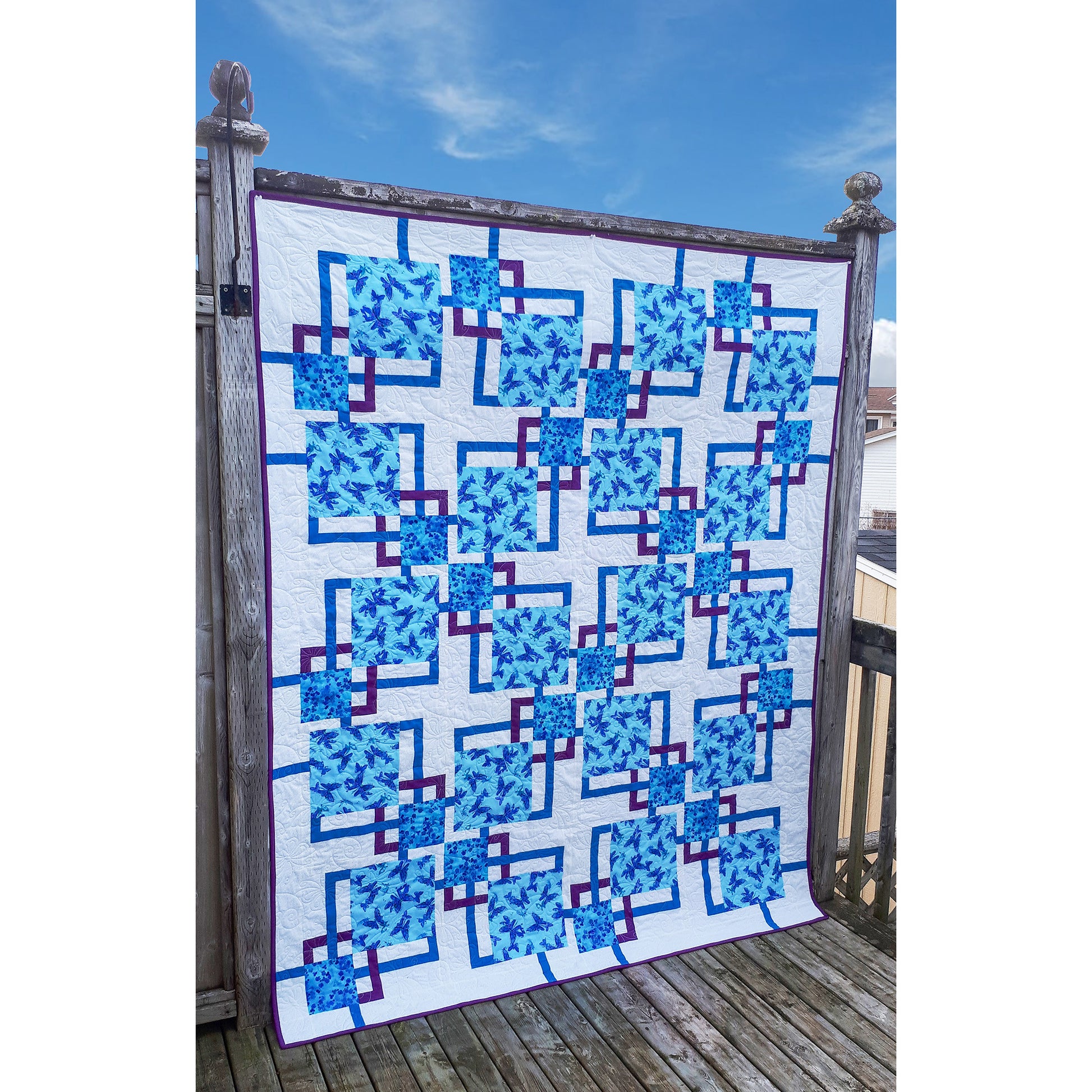 Pieced quilt pattern that features two focus prints and two accent colors in a modern setting. Instructions for five size options.