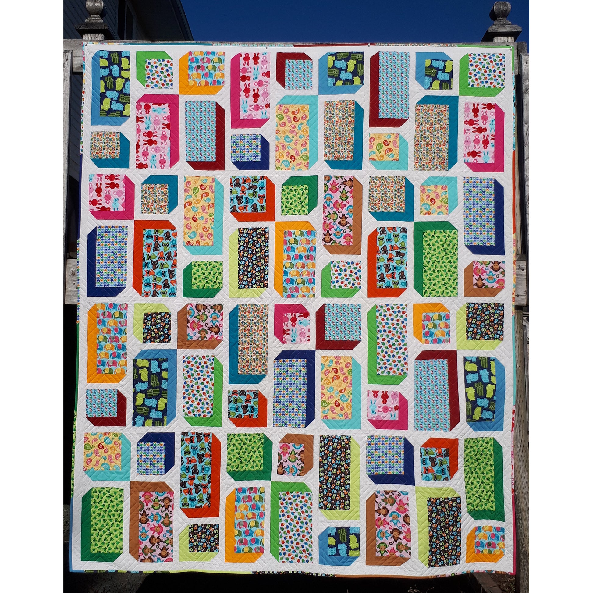  Vibrant modern quilt featuring alternating squares and rectangles in columns. Solid color fabrics on 2 sides of each block create a 3D effect.