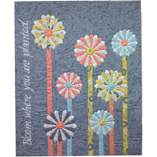 7 Dresden Star flower blooms on applique stems adorn this wall hanging. Bloom where you are planted is appliued up the left hand side.